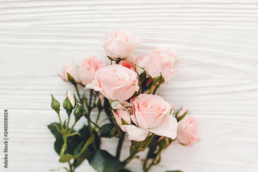 Pink small roses on wooden background, flat lay with space for text. Floral greeting card mockup. Wedding invitation,happy mother day or Valentine day concept. Hello spring. Pink small roses on wooden background, flat lay with space for text. Floral greeting card mockup. Wedding invitation,happy mother day or Valentine day concept. Hello spring.