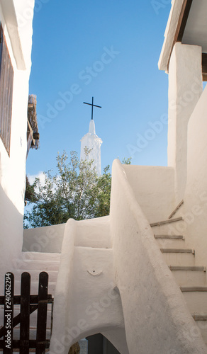 View of a typical church with white walls and roof of the fishing village Binibeca Menorca Spain photo