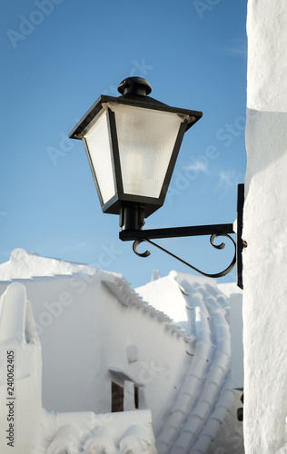 Typical residence with white wall roof and street light of fishing village Binibeca Menorca Spain photo