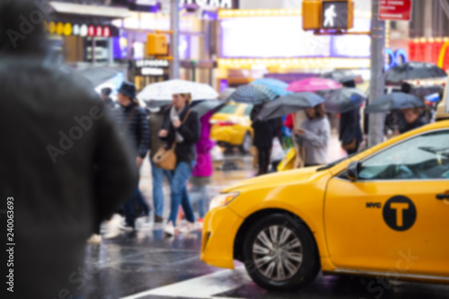 Blurred picture of a yellow cab speeds through Times Square, the busy tourist intersection of neon art and commerce. Times Square is also an iconic square of New York City. © Travel Wild