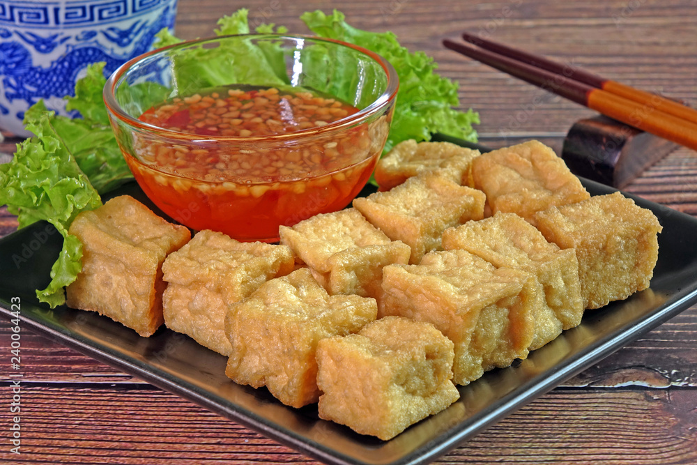 Tofu. Traditional fried Tofu , served with sweet chili sauce or sweet plum sauce. Famous Chinese appitizer / Chinese cuisine. Vegetarian food. Tofu. Traditional fried Tofu , served with sweet chili sauce or sweet plum sauce. Famous Chinese appitizer / Chinese cuisine. Vegetarian food.