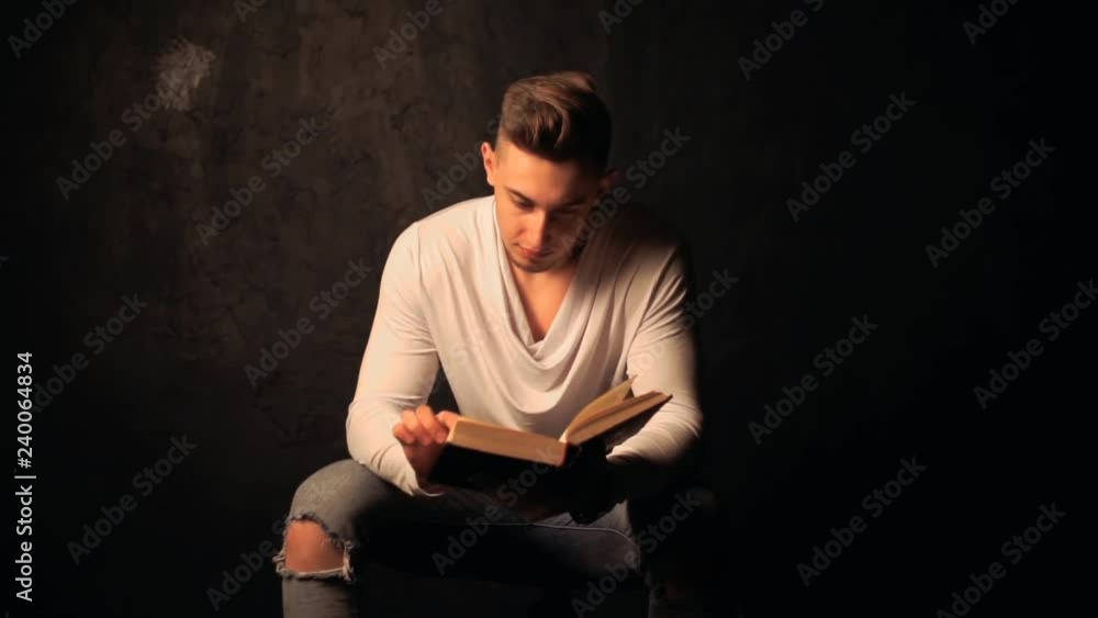 Young man reading an old book Young man reading an old book