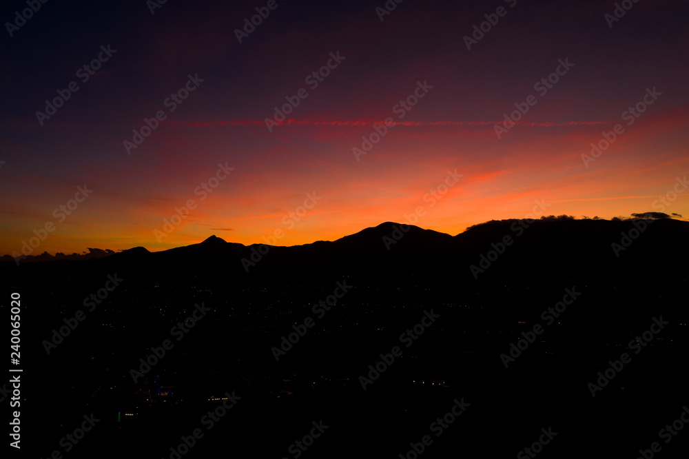Aerial view of a spectacular sunset behind some beautiful mountains in Italy.