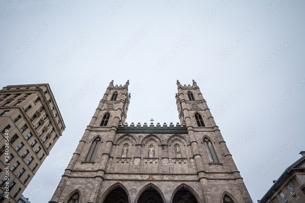 Notre Dame Basilica Skyline in the Old Montreal, with its main facade and its iconic towers. The basilica is the main cathedral of Montreal, Quebec, Canada, and a touristic landmark