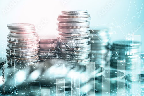 Double exposure of city and rows of coins with business graph for finance and banking concept