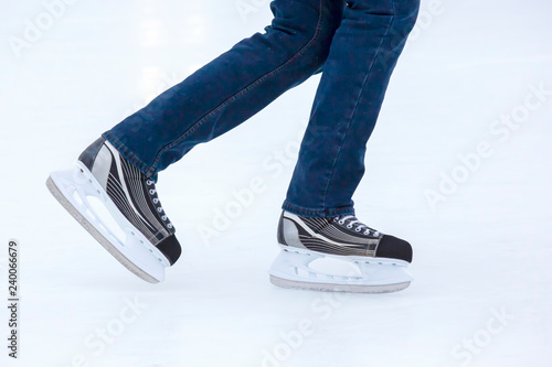 the legs of a man skating on an ice rink