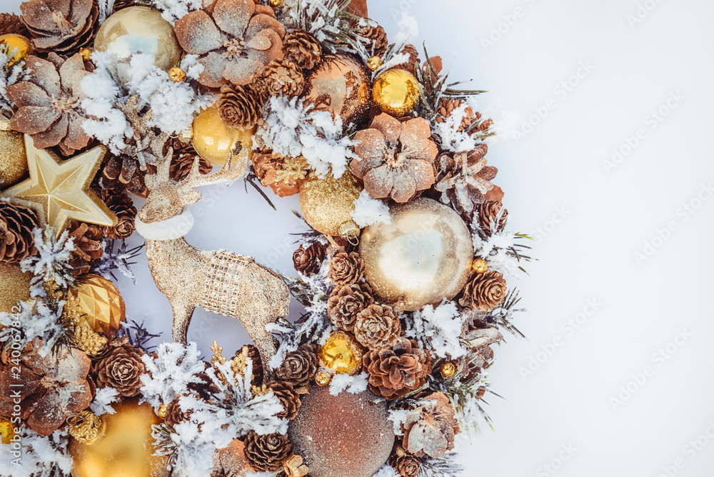 Top view Beautiful hand made golden Christmas wreath decorated with pine cones, ornamentals, spruce branches, balls, stars and decorative deer on white background isolated, flat lay. Copy space. Top view Beautiful hand made golden Christmas wreath decorated with pine cones, ornamentals, spruce branches, balls, stars and decorative deer on white background isolated, flat lay. Copy space.