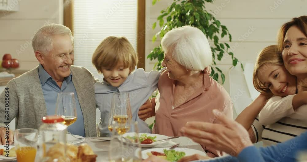 Close up of the grandparent with their lovely grandson and mother with daughter at the dinner table. Rear of the father. Close up of the grandparent with their lovely grandson and mother with daughter at the dinner table. Rear of the father.