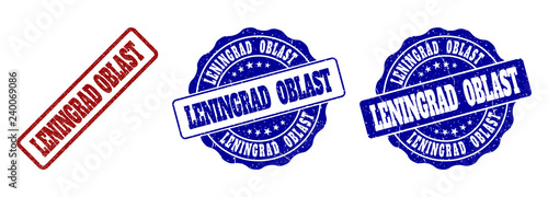 LENINGRAD OBLAST scratched stamp seals in red and blue colors. Vector LENINGRAD OBLAST labels with distress effect. Graphic elements are rounded rectangles, rosettes, circles and text labels.