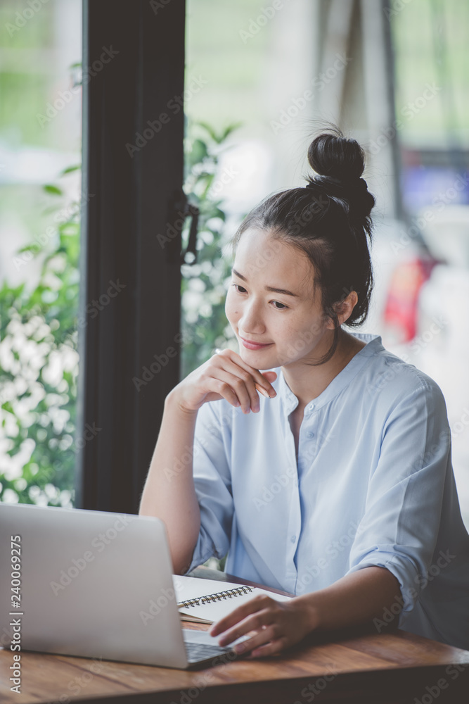 Asian girls sitting working comfortably at home. Asian girls sitting working comfortably at home.