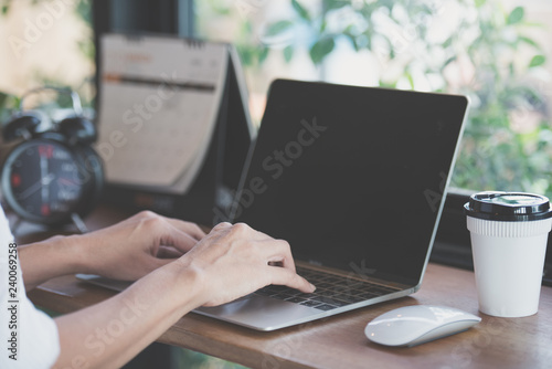 woman using laptop, searching web, browsing information, having workplace at coffee shop.
