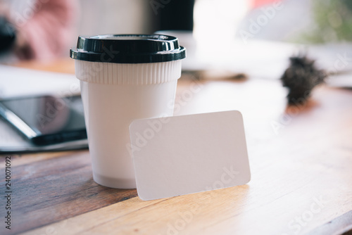 Blank paper placed next to a cup of coffee.