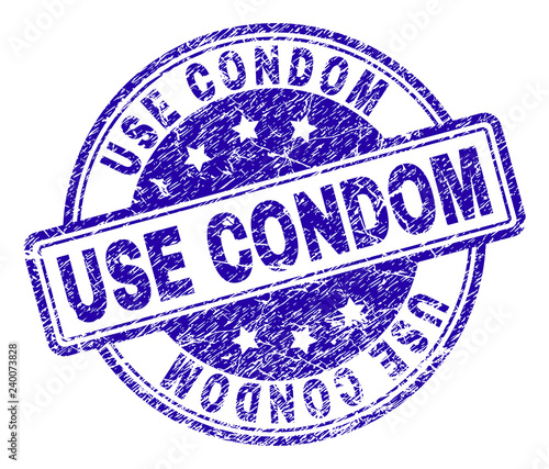 USE CONDOM stamp seal watermark with grunge texture. Designed with rounded rectangles and circles. Blue vector rubber print of USE CONDOM title with dust texture.