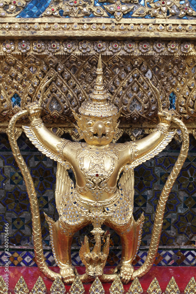 close up golden Garuda statue stand around , the bronze symbol of Thai government, giant ancient gold eagle with crown sculpture antique signature on temple royal palace wall close up golden Garuda statue stand around , the bronze symbol of Thai government, giant ancient gold eagle with crown sculpture antique signature on temple royal palace wall