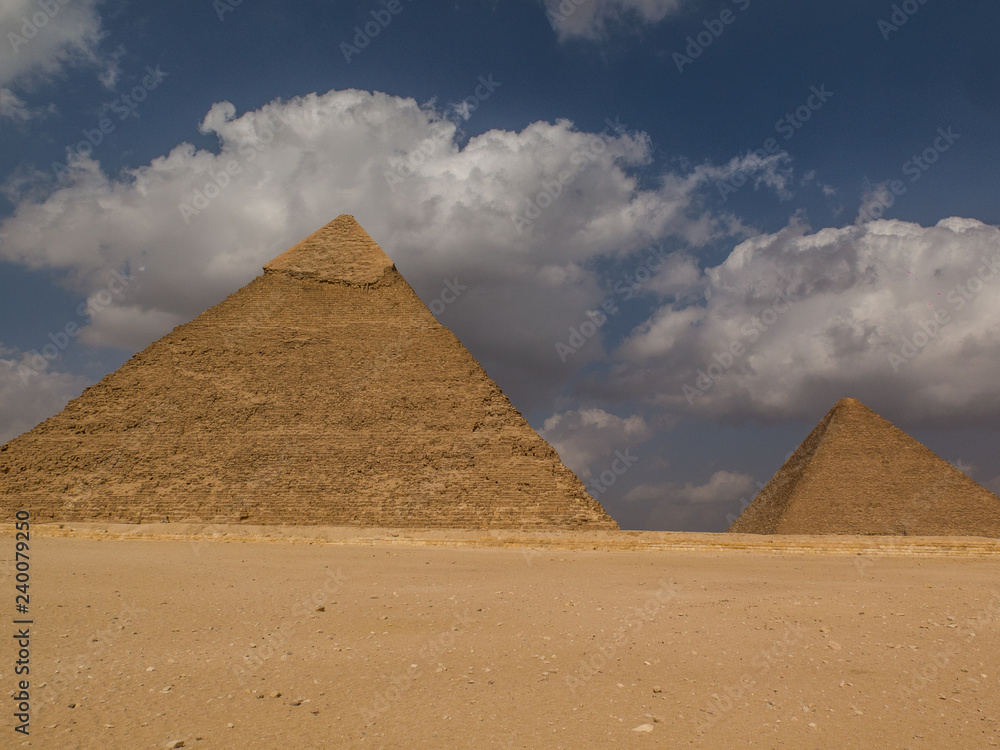 Two ancient pyramids under a blue sky with clouds Two ancient pyramids under a blue sky with clouds