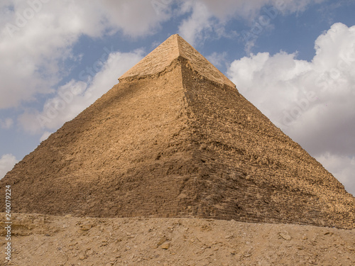 Great pyramid in Cairo Egypt on a sunny day with blue sky and white clouds