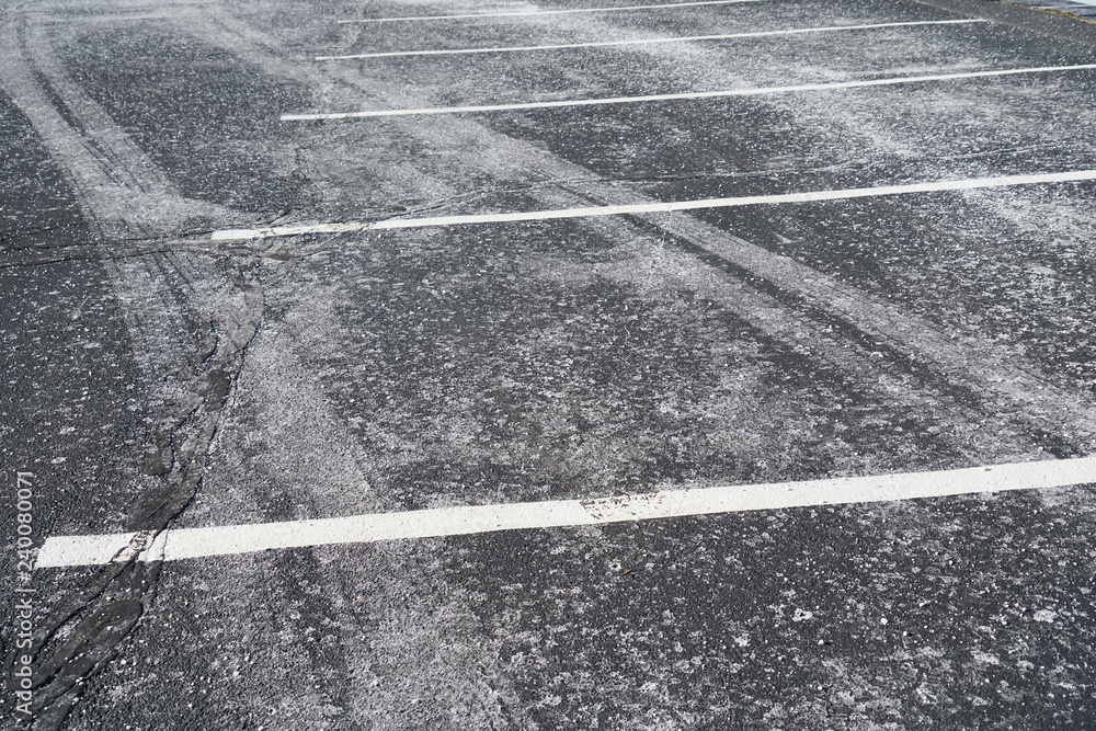 close up on parking lots with salt before snow in winter