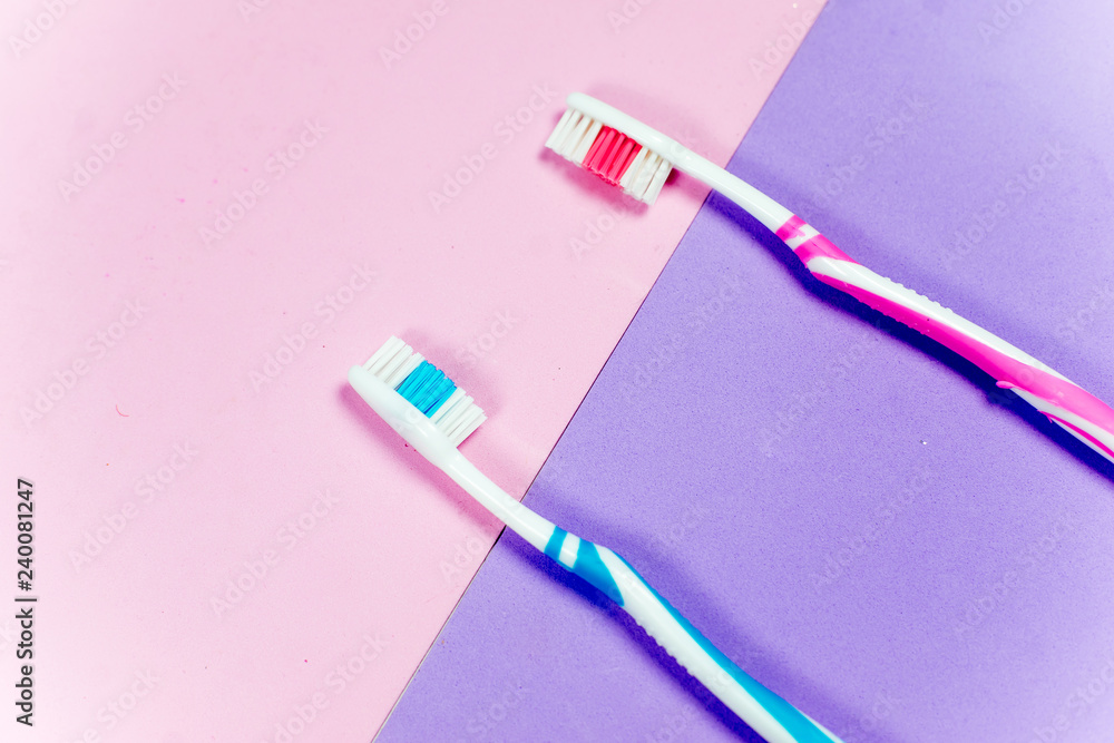 toothbrushes and a toothpaste on a colorful background toothbrushes and a toothpaste on a colorful background