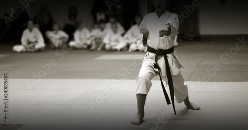 Children's training on karate-do. Banner with space for text. For web pages or advertising printing. Photo without faces, from the back.