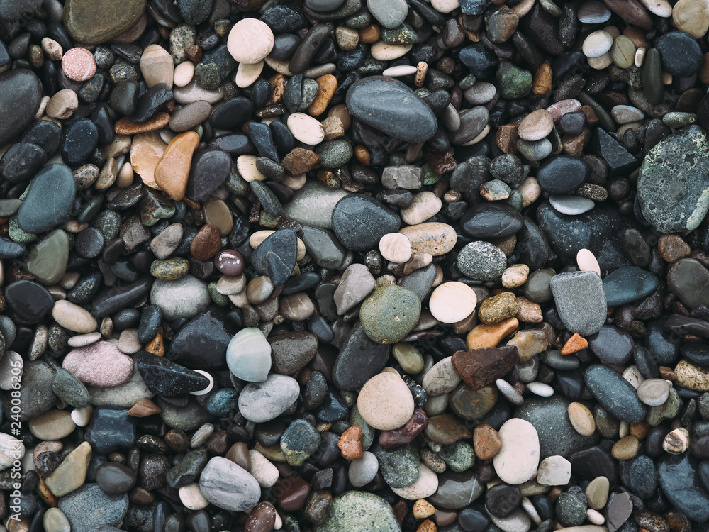 Naklejka premium Sea pebble on the beach. stones background.