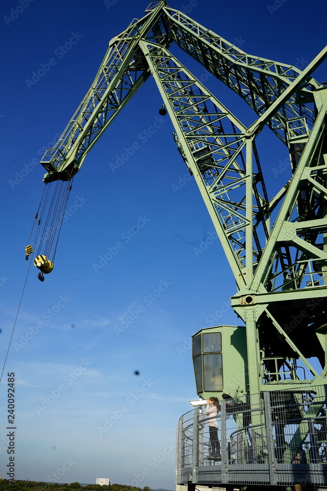 Fototapeta premium Industrial crane against blue sky