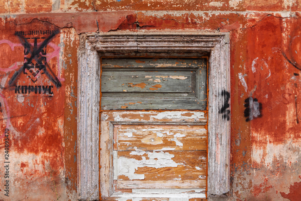 Wooden dyed boards. Wall with peeling paint of a old abandoned house. Background Wooden dyed boards. Wall with peeling paint of a old abandoned house. Background