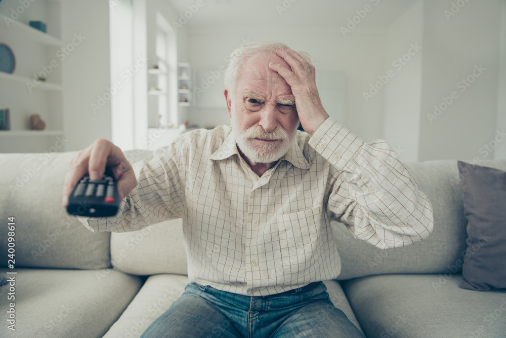 Portrait of nice irritated annoyed stylish old man sitting on di Portrait of nice irritated annoyed stylish old man sitting on di