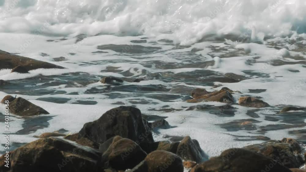 The waves crashing against the rock on the sea shore The waves crashing against the rock on the sea shore