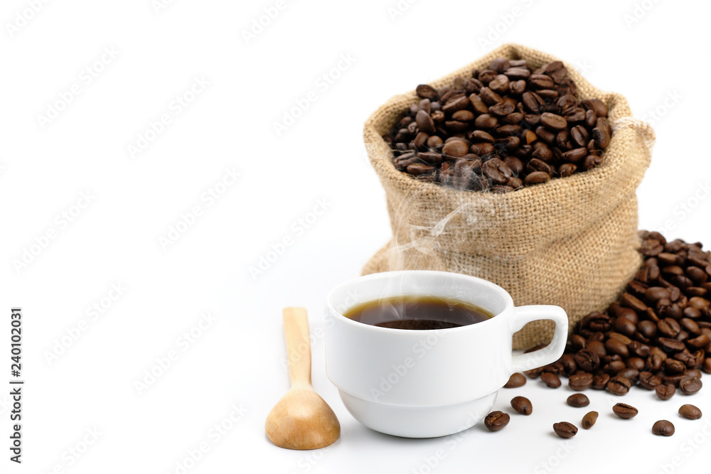 Fototapeta premium Coffee cup, coffee beans in sackcloth bag and some parts was poured on a white background.