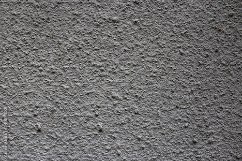 rough grey texture of the wall. small pimples