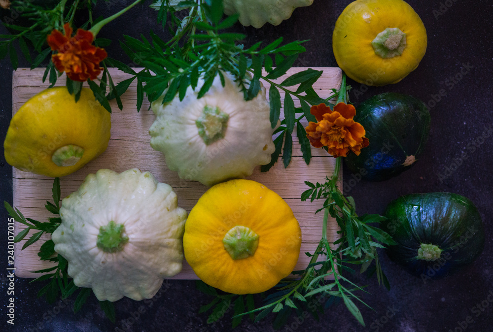 Multicolored yellow, white and green squash on the table