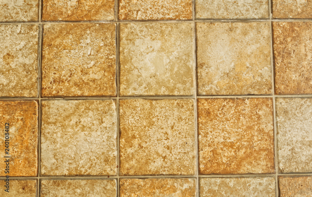 Naklejka premium Abstract brown tone marble stone block tiles pattern background in natural concept Decorative modern rough block texture background arrangement in asymmetry seamless wall of interior building design