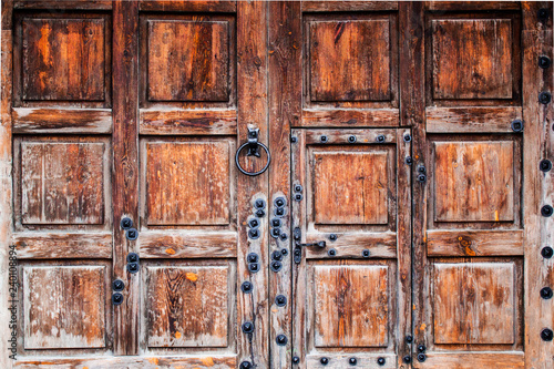 Midcentury wooden gates with iron rivets close up © Ivanna