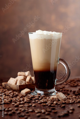 Fototapeta Naklejka Na Ścianę i Meble -  Coffee drink or cocktail with cream and pieces of brown sugar.