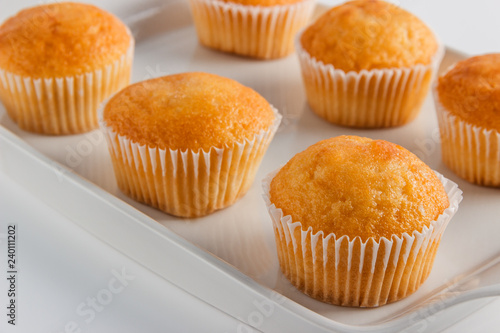 Cupcakes on a white plate on a light background close-up