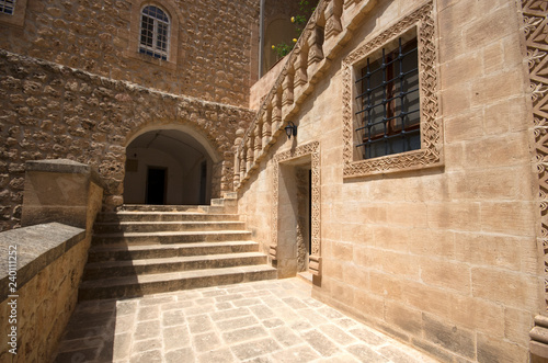 Fototapeta Naklejka Na Ścianę i Meble -  Mardin, Midyat / Turkey - May 17 / 2015: Courtyard details of Mor Gabriel (Deyrulumur) monastery