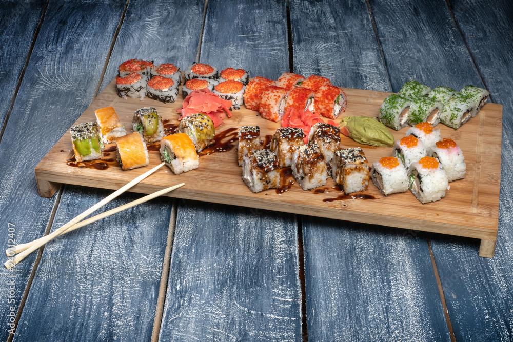 Japanese cuisine. Sushi rolls set served on a wooden table Japanese cuisine. Sushi rolls set served on a wooden table