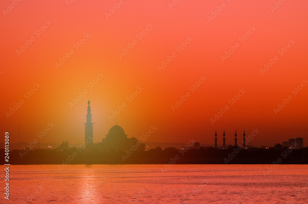 Silhouette of a mosque at sunrise