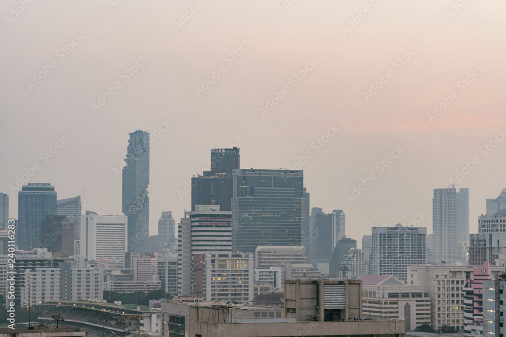Air pollution effect made low visibility cityscape with haze and fog from dust in the air during sunset in Bangkok, Thailand. Air pollution effect made low visibility cityscape with haze and fog from dust in the air during sunset in Bangkok, Thailand.