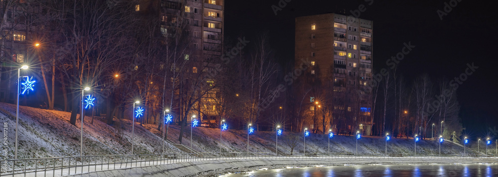 Jugla lake in Riga, It's travel photo. Urban photo, houses led lights with reflections. 2018. Jugla promenade.