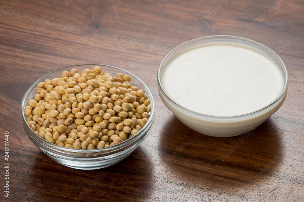Food : Bowls of Soy Milk And Soybeans Isolated on Wooden Background Food : Bowls of Soy Milk And Soybeans Isolated on Wooden Background