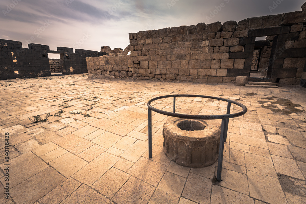 Naklejka premium Jordan - September 30, 2018: Ruins of an ancient castle in the dunes of the desert of Jordan