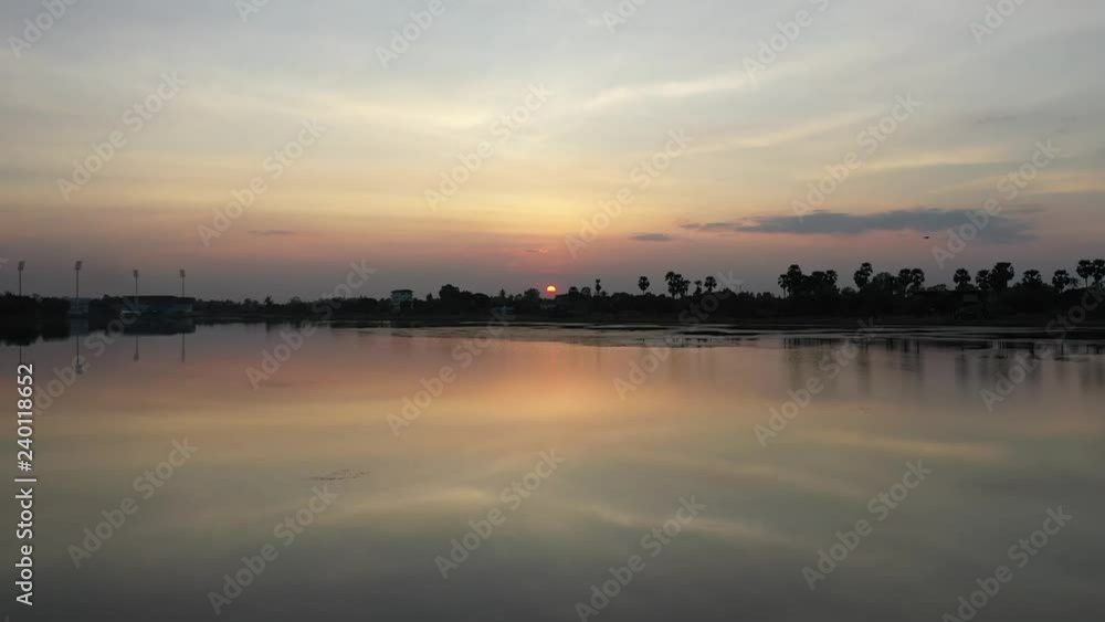 The island in the water with a bridge in the middle of the sunset The island in the water with a bridge in the middle of the sunset