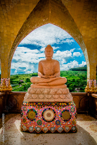 buddha statue beautiful sit on base colorful with blue sky and landscape nature background