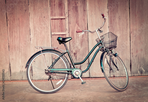 vintage bicycle on old wall / old bike on wall wooden house background