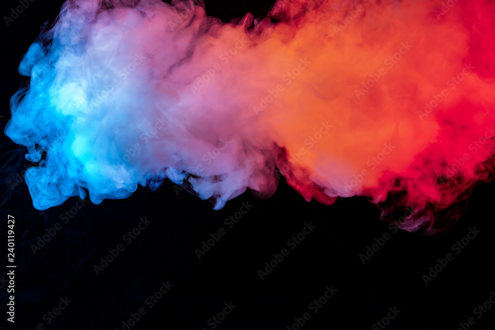 The beautiful color combination of blue, orange, violet and red hues from the substance is smoke, on a black background resembling the Milky Way.