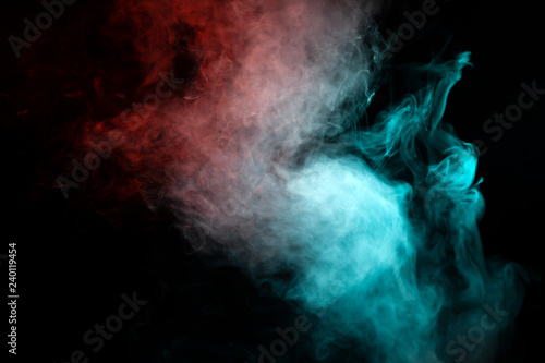 Translucent smoke rising to the top, illuminated by light on a dark background, multi-colored: blue, gray and red, evaporating in waves exhaled from the wape.