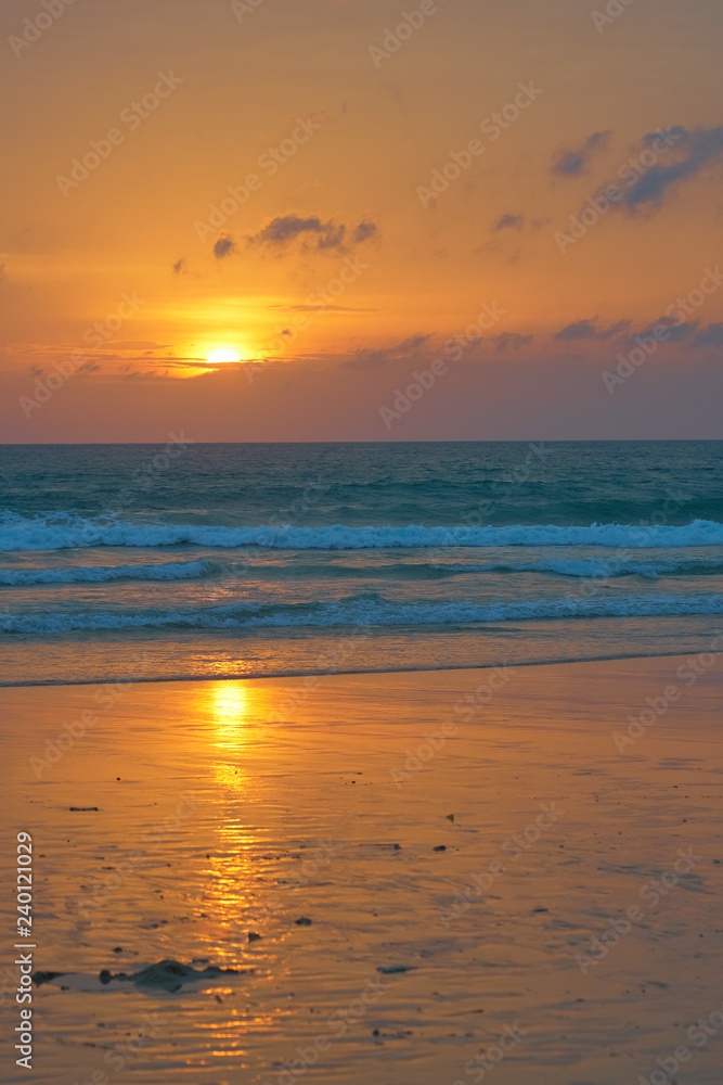 Spectacular sunset on the tropical ocean beach.