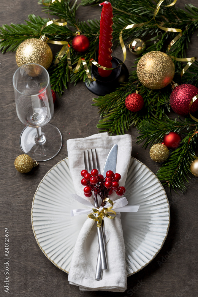 Christmas place setting with fork and knife, glass, ribbon and christmas decorations Christmas place setting with fork and knife, glass, ribbon and christmas decorations