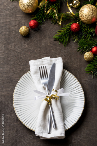 Christmas table setting with fork and knife and christmas decorations on plate